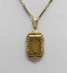 This is a antique gold filled locket made by the JJ White company. This company began business in 1896. I believe this locket is from around the turn of the century. The locket has a sliding mesh door that hides a picture within. I have paired it with a nice gold filled chain that appeared to have some age also. The locket is 1 3/4 by 7/8 inches, the chain is 19 inches. This necklace is in very good to excellent condition for its age with minimal signs of wear to the gold filled plating. The mesh door slides easily and it retains the original photo holder. This beautiful piece of history will arrive in a black velvet pouch. Free shipping. Antique Rectangular Formal Necklace, Vintage Rectangular Locket Jewelry, Victorian Antique Gold Necklace For Formal Occasions, Victorian Locket Necklaces For Vintage Events, Victorian Locket Necklace With Intricate Design For Formal Occasions, Victorian Locket Necklace With Intricate Design For Formal Events, Victorian Locket Necklace For Ceremonial Occasions, Victorian Yellow Gold Locket Necklace For Formal Occasions, Victorian Engraved Rectangular Necklace