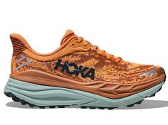 The HOKA Stinson ATR 7 is an incredibly versatile trainer that can take you from road to trail without skipping a beat. Get yours today! Orange Running Shoes With Air Cushioning For Trail, Orange Trail Running Shoes With Air Cushioning, Orange Trail Running Shoes With Rubber Sole, Orange Trail Running Shoes With Vibram Sole, Orange Cushioned Trail Running Shoes, Athleisure Trail Running Shoes With Rubber Sole, Orange Cushioned Running Shoes For Trail, Orange Trail Running Shoes With Rubber Sole For Outdoor, Orange Trail Running Shoes With Branded Insole