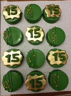 green and gold decorated cookies with the number fifteen on them