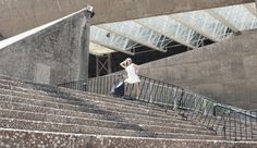 a woman is walking up some stairs with her luggage