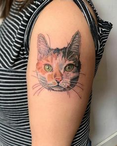 a woman with a cat tattoo on her arm