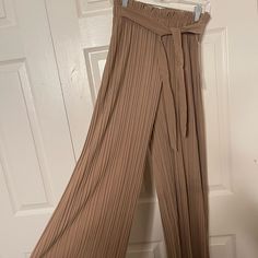 Nude Color Loose Pants. Very Cute With A Belt. Beige Pleated Full-length Bottoms, Brown Pleated Wide Leg Bottoms, Brown Pleated Wide-leg Bottoms, Elegant Beige Bottoms For Date Night, Brown Stretch Pleated Bottoms, Chic Stretch Taupe Bottoms, Stretch Brown Pleated Bottoms, Chic Beige Bottoms For Date Night, Beige Bottoms For Date Night In Spring