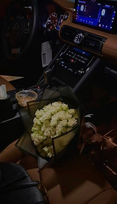 a bouquet of flowers sitting in the center of a car's dash board area