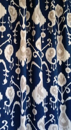 a blue and white curtain with flowers on it