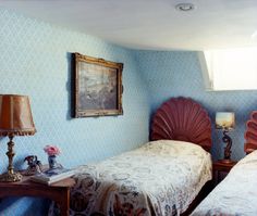 two beds in a room with blue walls