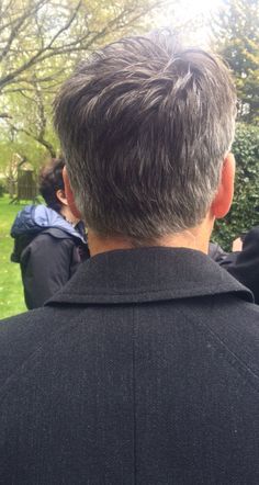 the back of a man's head with people in the background