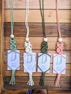 several different colored ropes hanging on a wooden wall