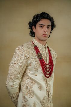 Butter Cream Sherwani | Jatin Malik Introducing our exquisite dirty ivory sherwani, a true work of art. This sherwani is intricately hand-embroidered with traditional chikankari motifs and embellishments, paying tribute to the time-honored art form. The meticulous craftsmanship highlights the rich heritage and cultural significance of chikankari, making this sherwani a perfect blend of elegance and tradition. Ideal for making a sophisticated statement, this ensemble embodies the essence of timeless artistry. Included in purchase: Sherwani, Kurta, Churidar Product Specification Color: Dirty Ivory Fabric: Linen silk Occasion: Engagement, Wedding, Bridal, Reception Style: Sherwani, Kurta, Churidar Care: Dry Clean Work: Hand Embroidery Customization options:Can be customized in any color or st Chikankari Motifs, Cream Sherwani, Jatin Malik, Embroidered Sherwani, Blouse Yoke, Dhoti Pants, Haldi Ceremony, Royal Look, Indian Wedding Outfits