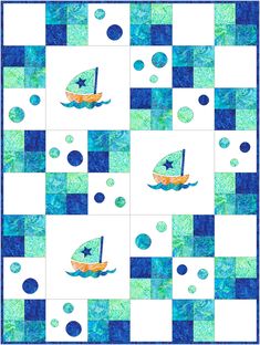 a blue and white quilt with a sailboat in the water on it's side