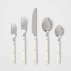 four forks, two knives and three spoons on a white surface with the same design