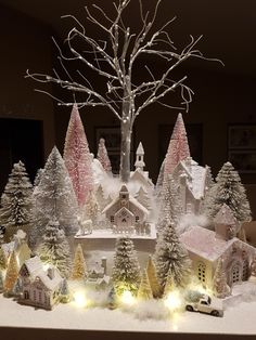 a christmas village with lights and trees