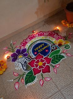 a decorated floor with candles and flowers on it for diwaling or celebrating the festival