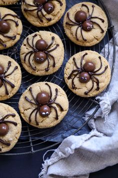 cookies with chocolate spider decorations are on a wire cooling rack, ready to be eaten