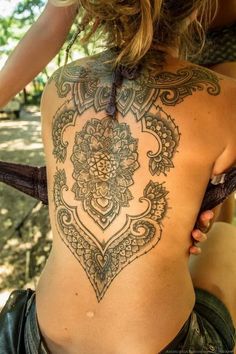 a woman with a tattoo on her back