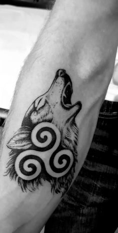 a man with a wolf tattoo on his arm