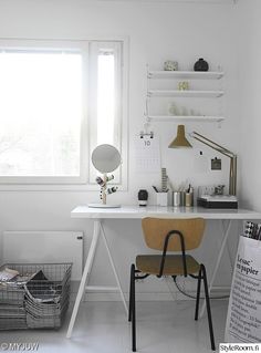 a white desk and chair in a small room