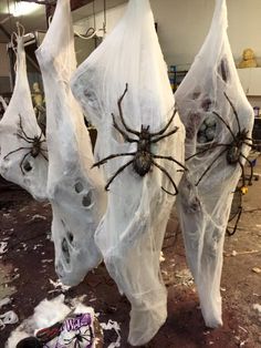 three large spider statues are wrapped in plastic