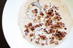 a bowl filled with oatmeal topped with nuts