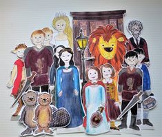 children's paper cutouts of people and animals in front of a door with a lion on it