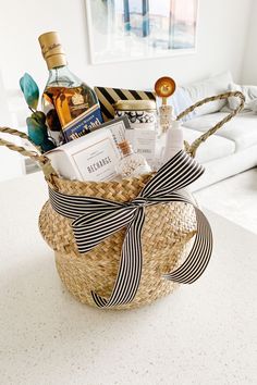 a basket filled with personal care items on top of a white table next to a couch