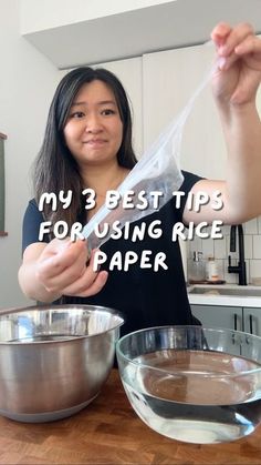 a woman holding up a plastic bag in front of a mixing bowl with ingredients on the counter