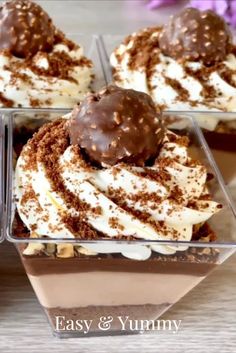 four desserts with chocolate and whipped cream in glass dishes on a wooden table top