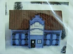 a blue building with a brown roof in the snow