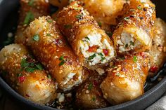 some food is in a black bowl on a table and it looks like they have been cooked