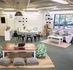 an office with couches, chairs and tables in it's center room area