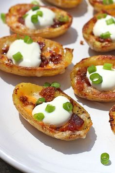 small appetizers with cheese and green onions are on a white plate, ready to be eaten