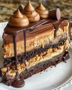 a piece of cake with chocolate and peanut butter on top sitting on a white plate