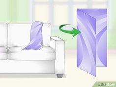 a white couch with purple sheets on it and an arrow pointing to the left side