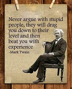 an old man sitting on top of a chair next to a wooden wall with a quote from mark twain