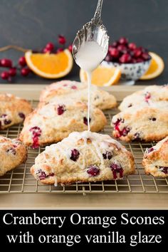 cranberry orange scones on a cooling rack being drizzled with icing