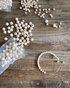 beads and string laid out on a wooden table