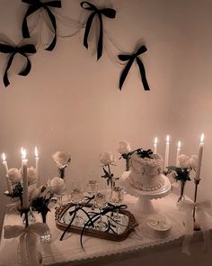 a table topped with a cake and lots of candles