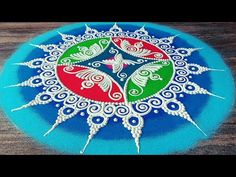 a blue plate with white and red designs on the top, sitting on a wooden table