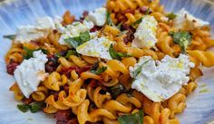 a plate full of pasta with cheese and herbs