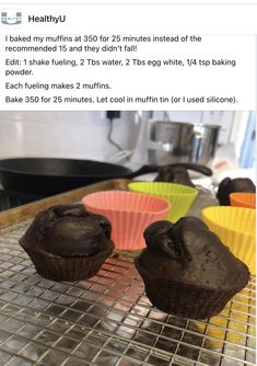 some muffins sitting on top of a cooling rack next to other cupcakes