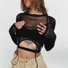 Crop Top Sheer Mesh Material High Neckline Long Sleeves Lined Bust With Buckles Attached Cropped Silhouette Buckle 95% Polyester, 5% Spandex Take Care Of Me Cold Hand Wash Size & Fit Fits True To Size Alexia Is Wearing Size S Alexia’s Stats: Height 5'8", Bust: 32, Waist: 24, Hips: 34, Size 2 Black Mesh Y2k Top For Spring, Black Mesh Y2k Tops, Black Mesh Top Y2k Style For Spring, Black Y2k Mesh Top For Spring, Black Stretch Mesh Top Y2k Style, Black Stretch Mesh Top In Y2k Style, Black Sheer Stretch Crop Top, Black Y2k Stretch Mesh Top, Black Y2k Mesh Top For Summer