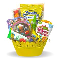 a yellow basket filled with lots of toys and candys on top of a white surface