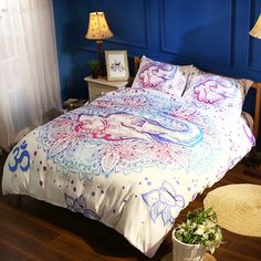 a bedroom with blue walls and white bedding has an ombrephant design on the comforter