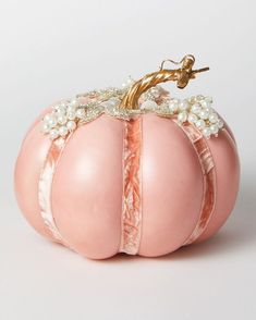 a pink pumpkin with pearls on it