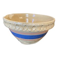 a white and blue striped bowl on a white background