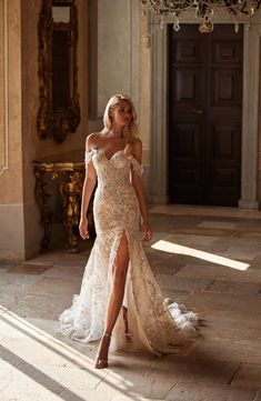 a woman in a wedding dress is posing for the camera