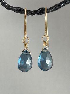 London blue quartz earrings. These beautiful blue briolettes are faceted, semi translucent and are approximately 10x12 mm in size, wrapped in 14K gold filled wire. Length is just over 1 inch. Ear wires are hand crafted by me, from 14K gold filled wire. All earrings come in an elegant gift box wrapped with ribbon. I will ship anywhere; cost of shipping dependent on destination. If you are interested in a custom order or have any questions, please do not hesitate to contact me. Thank you! Beth, of Blue Briolette Teardrop Earrings For Gift, Blue Briolette Wire Wrapped Earrings, Purple Necklace, Semi Precious Beads, Ruby Earrings, Wire Wrapped Earrings, Black Jewelry, Blue Quartz, Swarovski Earrings