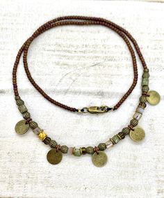 Brown and green necklace, bead choker necklace with bronze discs Back beads: 2mm miyuki seed beads Centre beads: czech glass and bronze beads, jasper gemstones and 1cm antique bronze discs Clasp: Antique bronze lobster clasp with 3cm extender Postage: UK: Items are sent 2nd class mail, but can be upgraded to 1st class mail for a small fee at checkout. International mail is sent by Royal Mail, untracked. Handmade necklace, custom orders gladly accepted Thank you for looking and hope you find some Green Bead Necklace, Bead Choker Necklace, Green Beaded Necklace, Bead Choker, Necklace Bead, Brown And Green, Women Gifts, Beaded Choker Necklace, Necklaces For Women