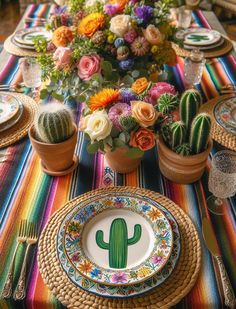 the table is decorated with colorful flowers and cactus plates