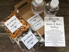 some cookies and water are sitting in a box on the table next to each other