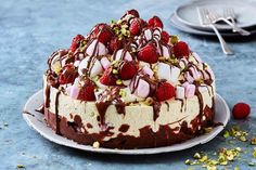 a cake with strawberries and chocolate drizzled on top